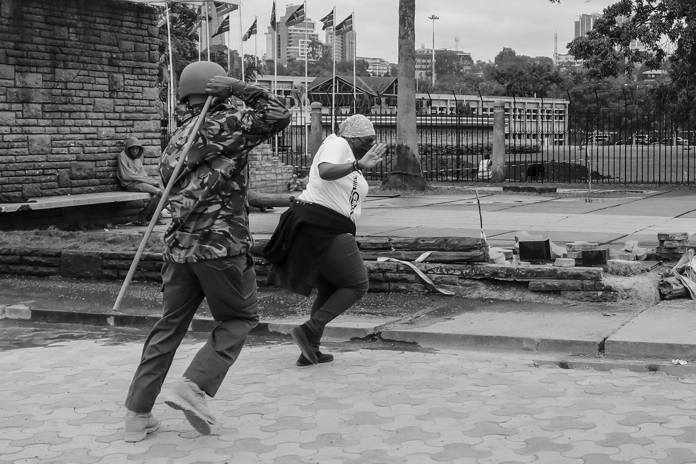 A Kenyan activist tries to guard herself from being beaten by a police officer during a protest in Nairobi, 7 July 2021 Photo: Daniel Irungu/EPA-EFE/Shutterstock.com