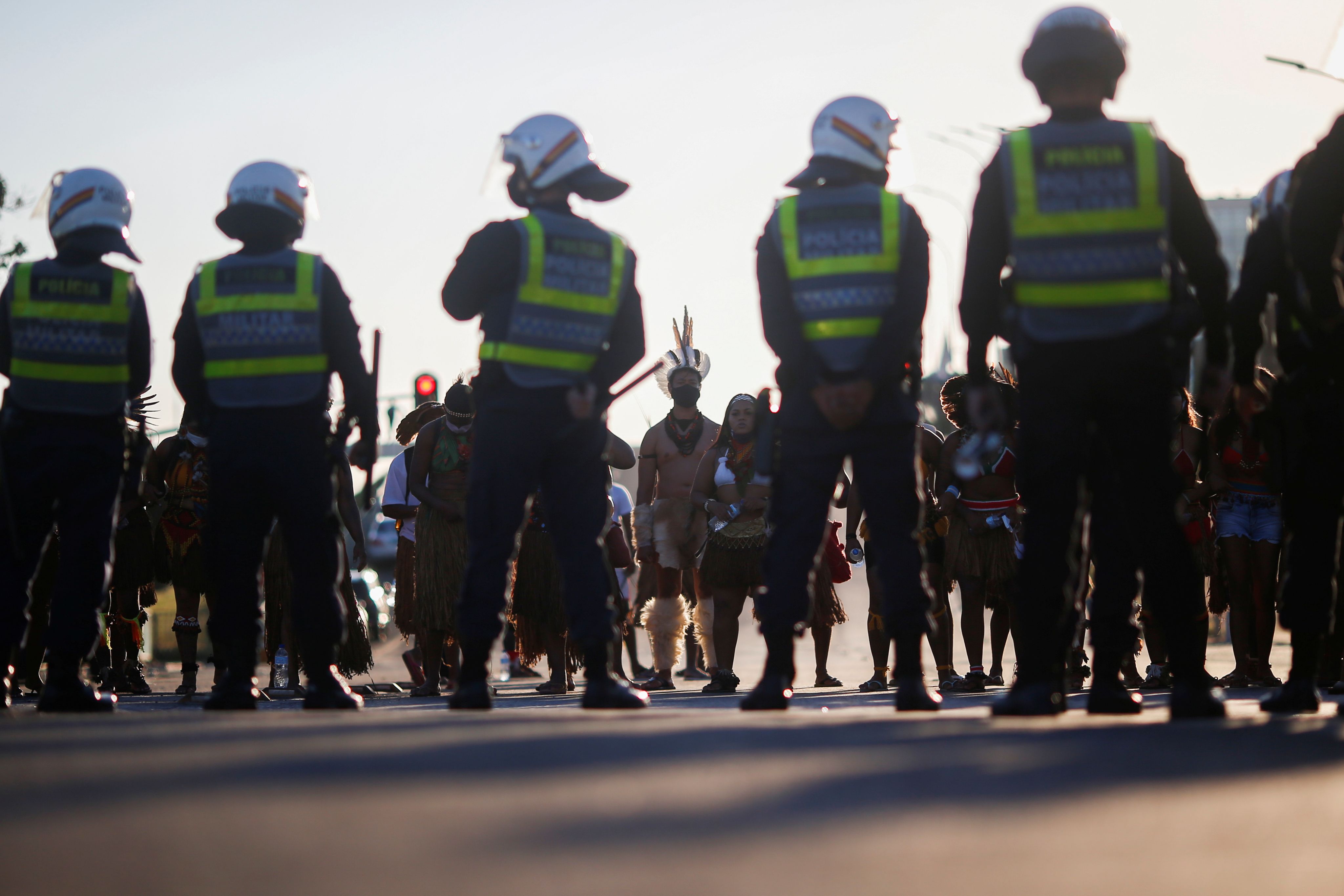 A police line in front of Indigenous Brazilian protesters
