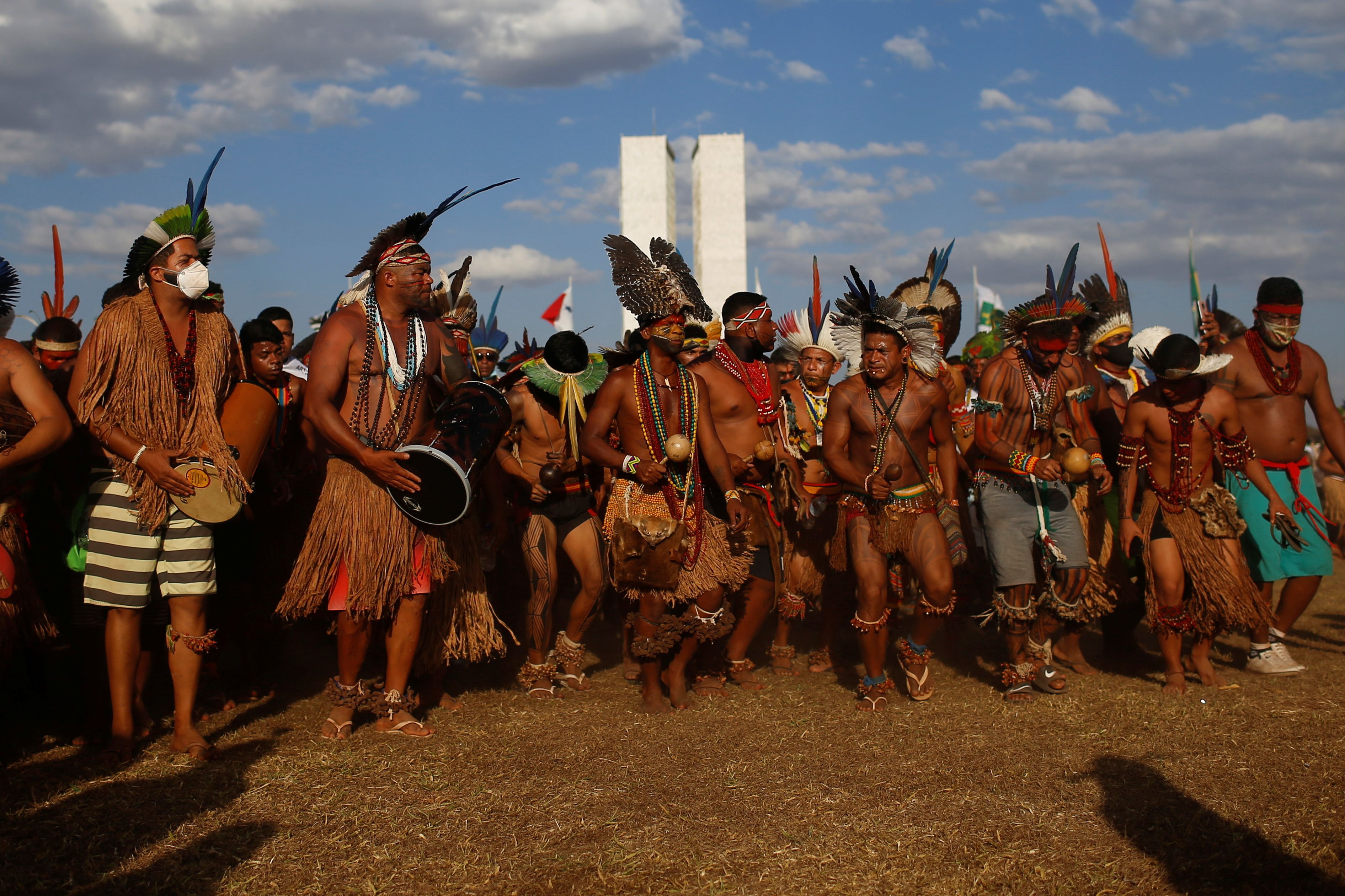 Indigenous people dancing and drumming at a protest