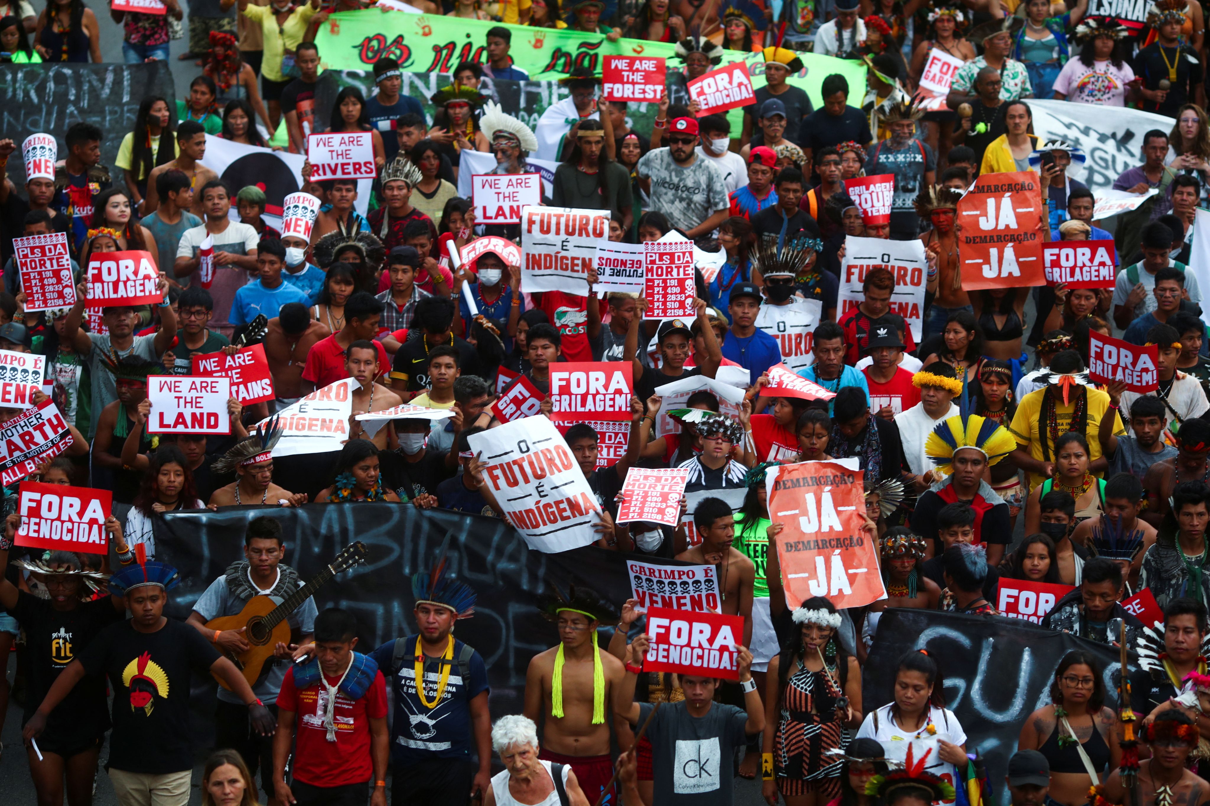 Crowd of Indigenous protesters holding banners